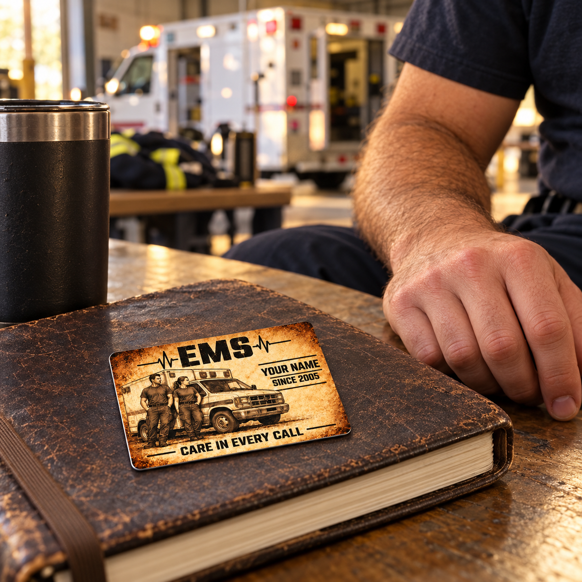 EMS Sepia Legacy wallet card resting on a worn leather journal at a station crew bench.