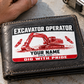The printed front of the Excavator Operator Red Monochrome Craft aluminum wallet card shown in an occupational lifestyle setting with an adult worker.