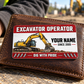 The printed front of the Excavator Operator Red Header aluminum wallet card shown in an occupational lifestyle setting with an adult worker.