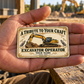 The printed front of the Excavator Operator Ivory Heritage Tribute aluminum wallet card shown in an occupational lifestyle setting with an adult worker.