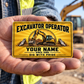 The printed front of the Excavator Operator Golden Milestone aluminum wallet card shown in an occupational lifestyle setting with an adult worker.