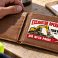 The printed front of the Excavator Operator Signature Modern aluminum wallet card shown in an occupational lifestyle setting with an adult worker.