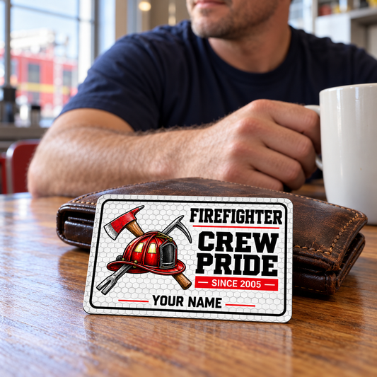 White honeycomb firefighter card beside a brown wallet as an adult man takes a coffee break at a station table.