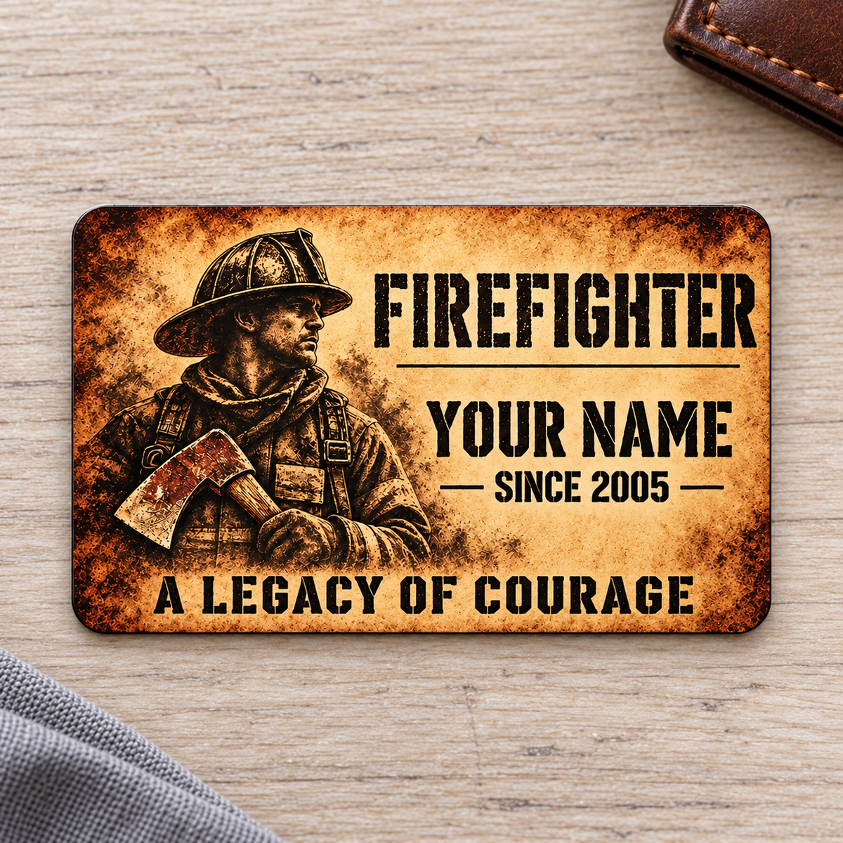 Firefighter sepia legacy aluminum wallet card front on pale ash wood.