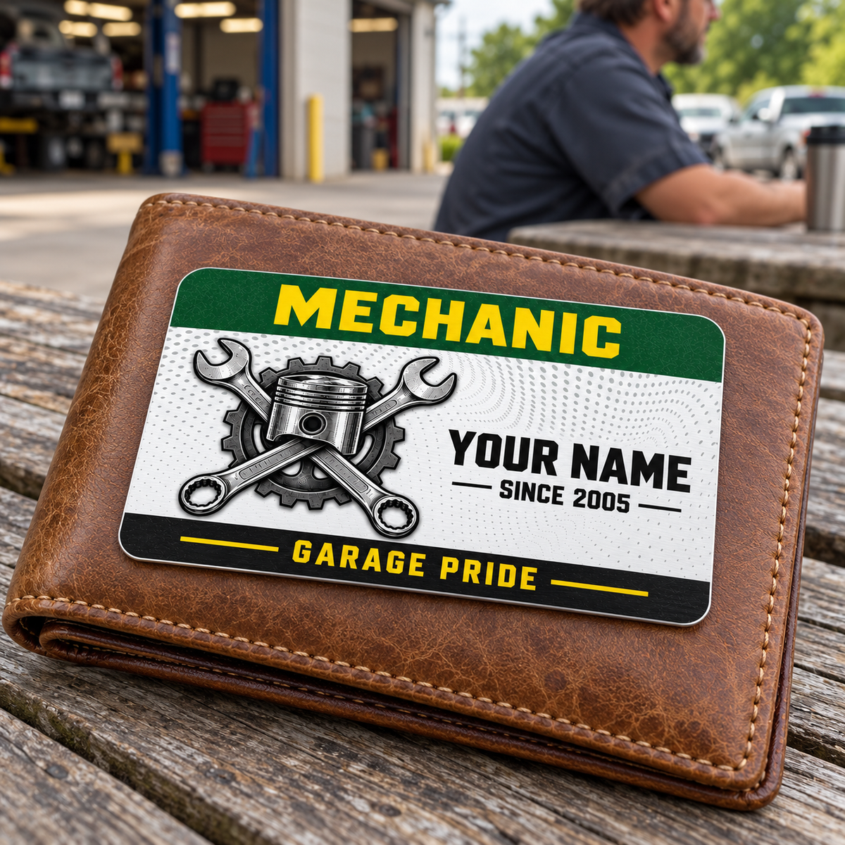 Mechanic Green Band aluminum wallet card shown at wallet scale in an automotive workshop setting.