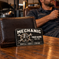 Mechanic Midnight Pride aluminum wallet card leaning against a dark leather wallet during a warm evening garage break.