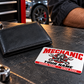 Mechanic Signature Modern aluminum wallet card shown at wallet scale in an automotive workshop setting.
