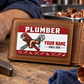 The printed front of the Plumber Red Header Trade Pride aluminum wallet card shown in an occupational lifestyle setting with an adult worker.