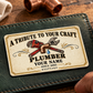 The printed front of the Plumber Ivory Heritage Tribute aluminum wallet card shown in an occupational lifestyle setting with an adult worker.