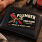 The printed front of the Plumber Midnight Trade Pride aluminum wallet card shown in an occupational lifestyle setting with an adult worker.