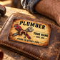 The printed front of the Plumber Sepia Craft Legacy aluminum wallet card shown in an occupational lifestyle setting with an adult worker.