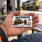 Railroader Minimal Tool Grid aluminum wallet card resting on an adult worker's open palm in a depot crew area.
