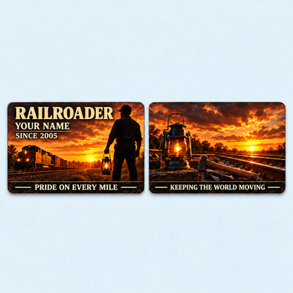 Railroader Sunset Workday aluminum keepsake wallet card, front and reverse views. A dramatic amber sunset silhouettes a railroad worker and locomotive, with cream lettering and a dark lower slogan band. The reverse pairs a glowing lantern and track tools with KEEPING THE WORLD MOVING, celebrating pride in every mile.