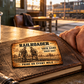 Railroader Sepia Legacy aluminum keepsake wallet card resting flat on a worn work journal beside an adult worker's hand.