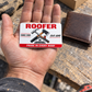 The printed front of the Roofer Signature Classic aluminum wallet card shown in an occupational lifestyle setting with an adult worker.