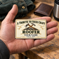 The printed front of the Roofer Ivory Heritage Tribute aluminum wallet card shown in an occupational lifestyle setting with an adult worker.