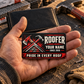 The printed front of the Roofer Midnight Trade Pride aluminum wallet card shown in an occupational lifestyle setting with an adult worker.