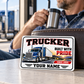 Trucker Honeycomb Pride wallet card against a closed leather wallet at a quiet truck-stop coffee break