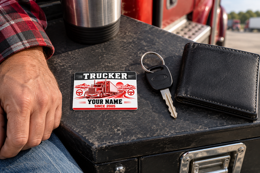 Trucker Red Monochrome card on a charcoal toolbox beside a truck key and closed wallet