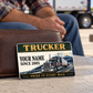 Trucker Heritage Band card leaning against a closed brown wallet on a pale rest-stop bench