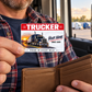 Adult trucker holding a Red Header aluminum wallet card above an open tan wallet in a parked cabin