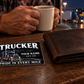 Trucker Midnight Pride wallet card beside a closed wallet during an evening truck-stop coffee break