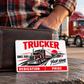 Trucker Signature Modern card leaning against a closed wallet on a slate rest-stop ledge