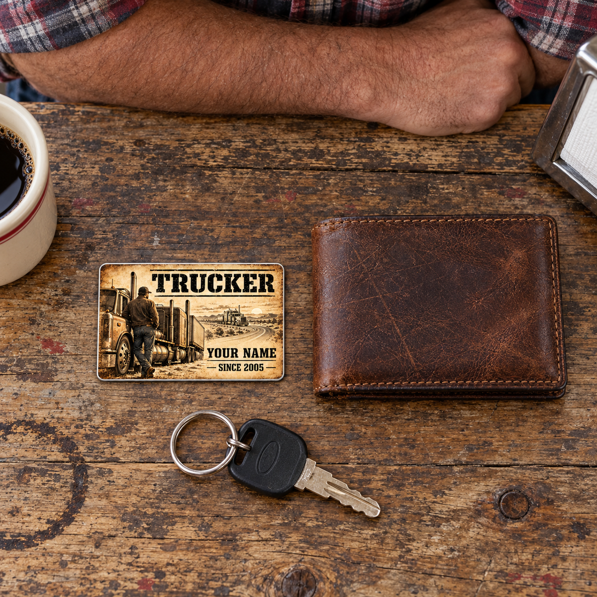 Trucker Sepia Legacy wallet card on a worn wooden break table beside a closed wallet and truck key