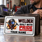 Welder Honeycomb Pride wallet card in a quiet metal fabrication workshop with inactive welding hood and steel bench break scene
