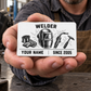 Adult welder presents the Minimal Tool Grid wallet card on an open hand