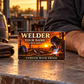 Welder Sunset Workday card beside a wallet and resting forearm in warm evening light