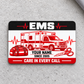 Red Monochrome EMS aluminum wallet card on light-gray concrete