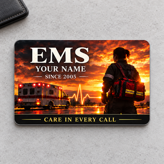 Sunset EMS aluminum wallet card on warm-gray concrete