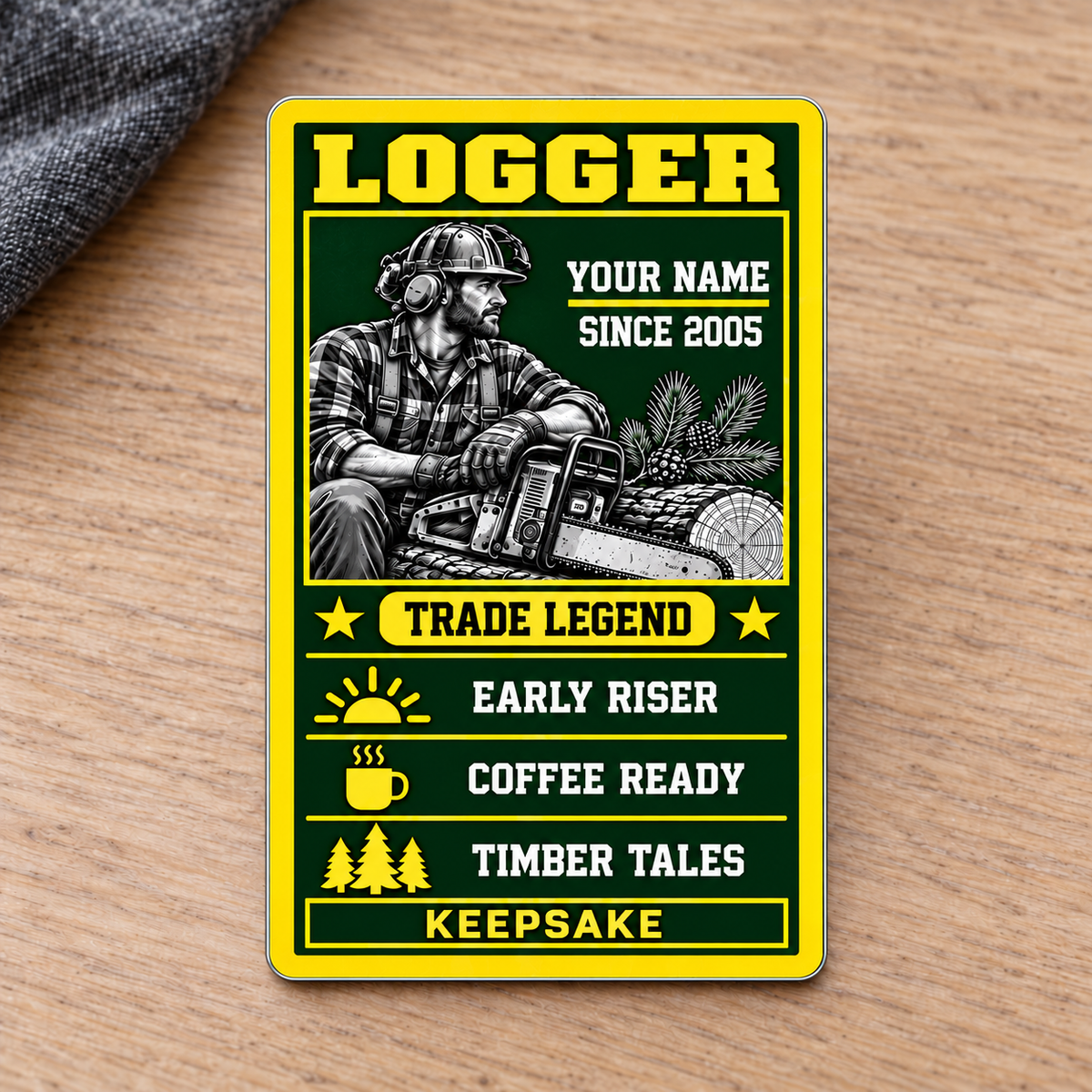 Logger Trade Legend portrait aluminum wallet card front on pale oak with charcoal fabric.