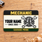Front of Mechanic Heritage Band aluminum wallet card on warm oak with a socket.