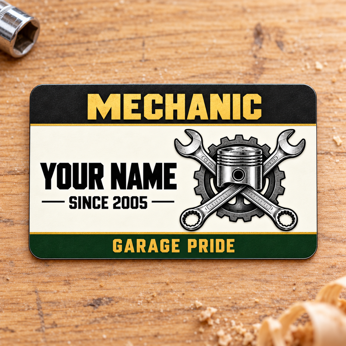 Front of Mechanic Heritage Band aluminum wallet card on warm oak with a socket.