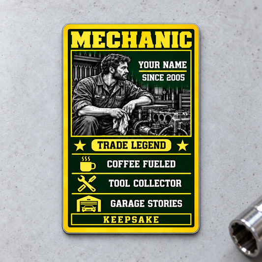 Portrait front of Mechanic Trade Legend aluminum wallet card on pale gray concrete.