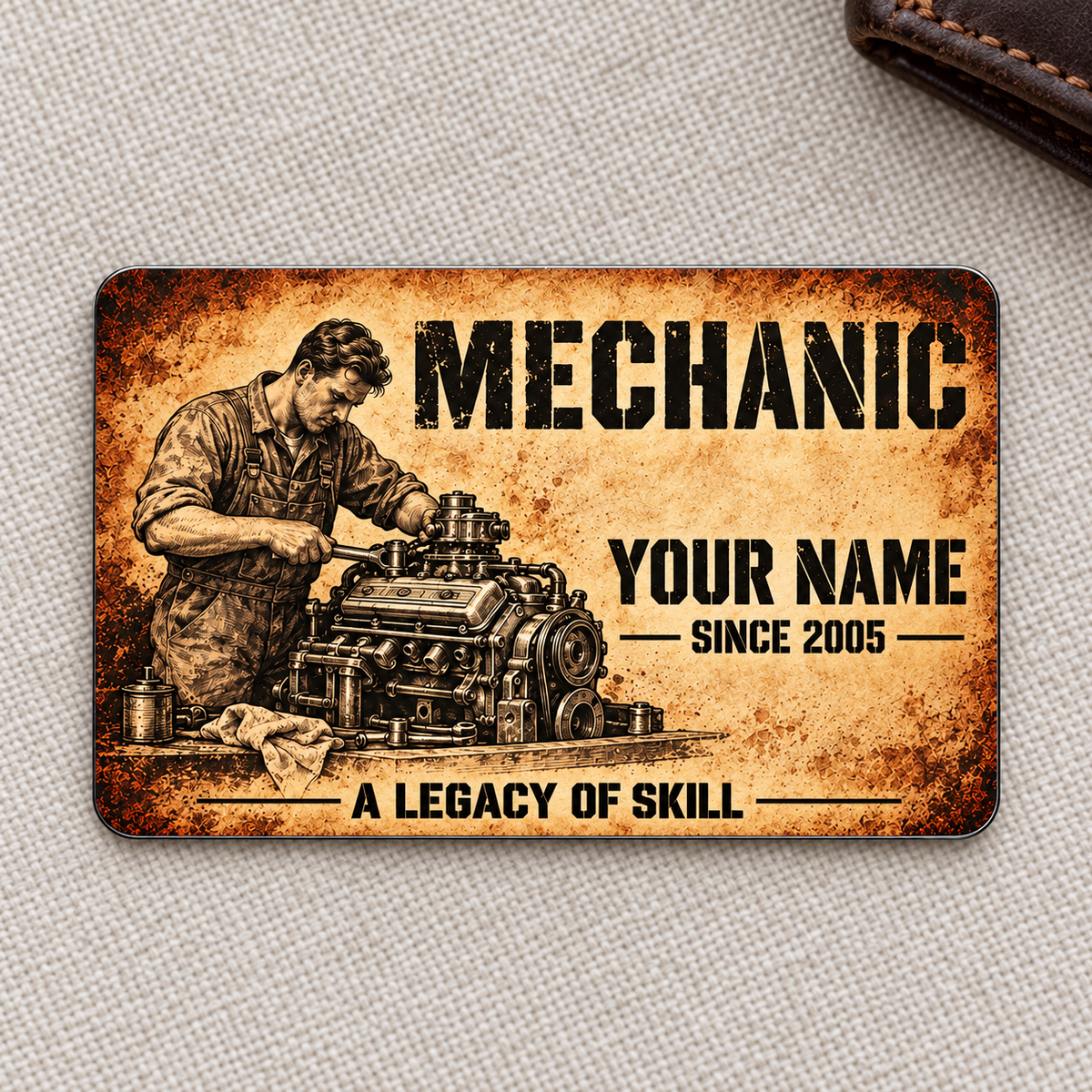 Front of Mechanic Sepia Legacy aluminum wallet card on woven fabric with a wallet corner.
