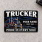 Front of Trucker Midnight Pride aluminum wallet card on pale gray concrete